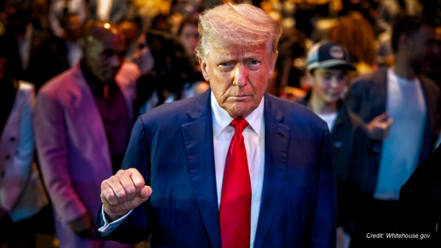 President Trump attending a UFC match with his trademark fist bump pose.